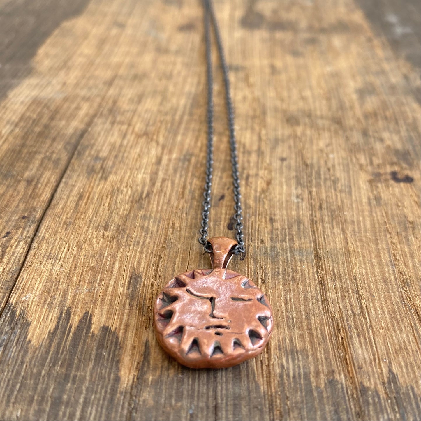 Copper Sun Pendant on Black Chain