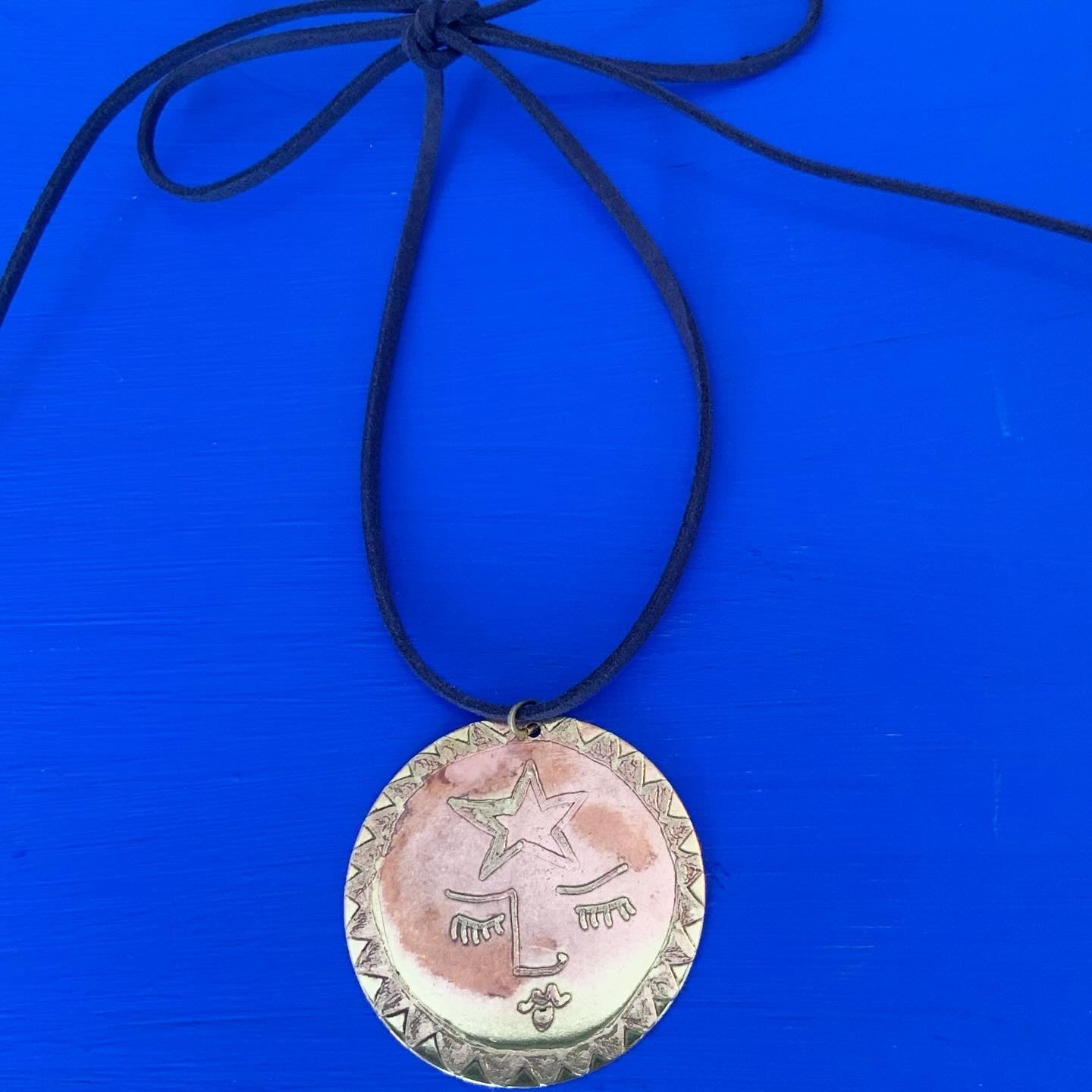 SISTER SUN 16 Brass pendant on blue cord