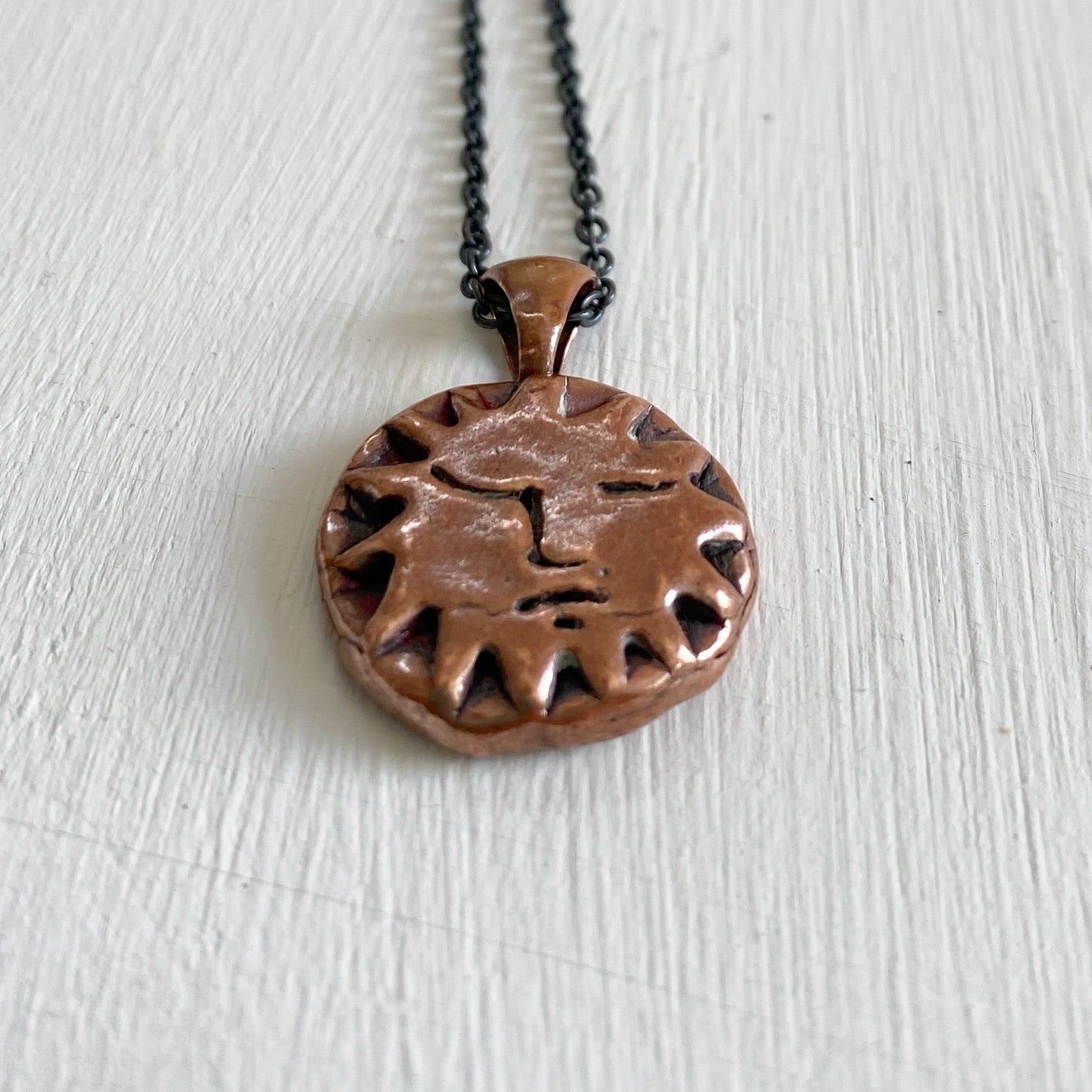 Copper Sun Pendant on Black Chain