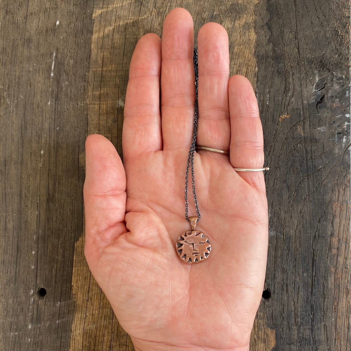 Copper Sun Pendant on Black Chain