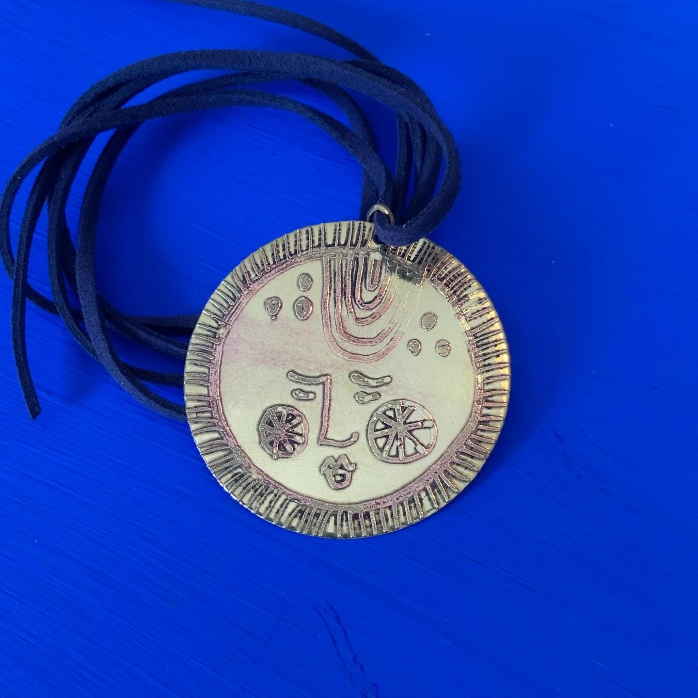 SISTER SUN 19 Brass pendant on blue cord