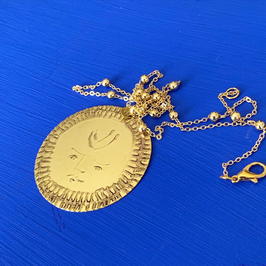 SISTER SUN 18 Brass pendant on blue cord