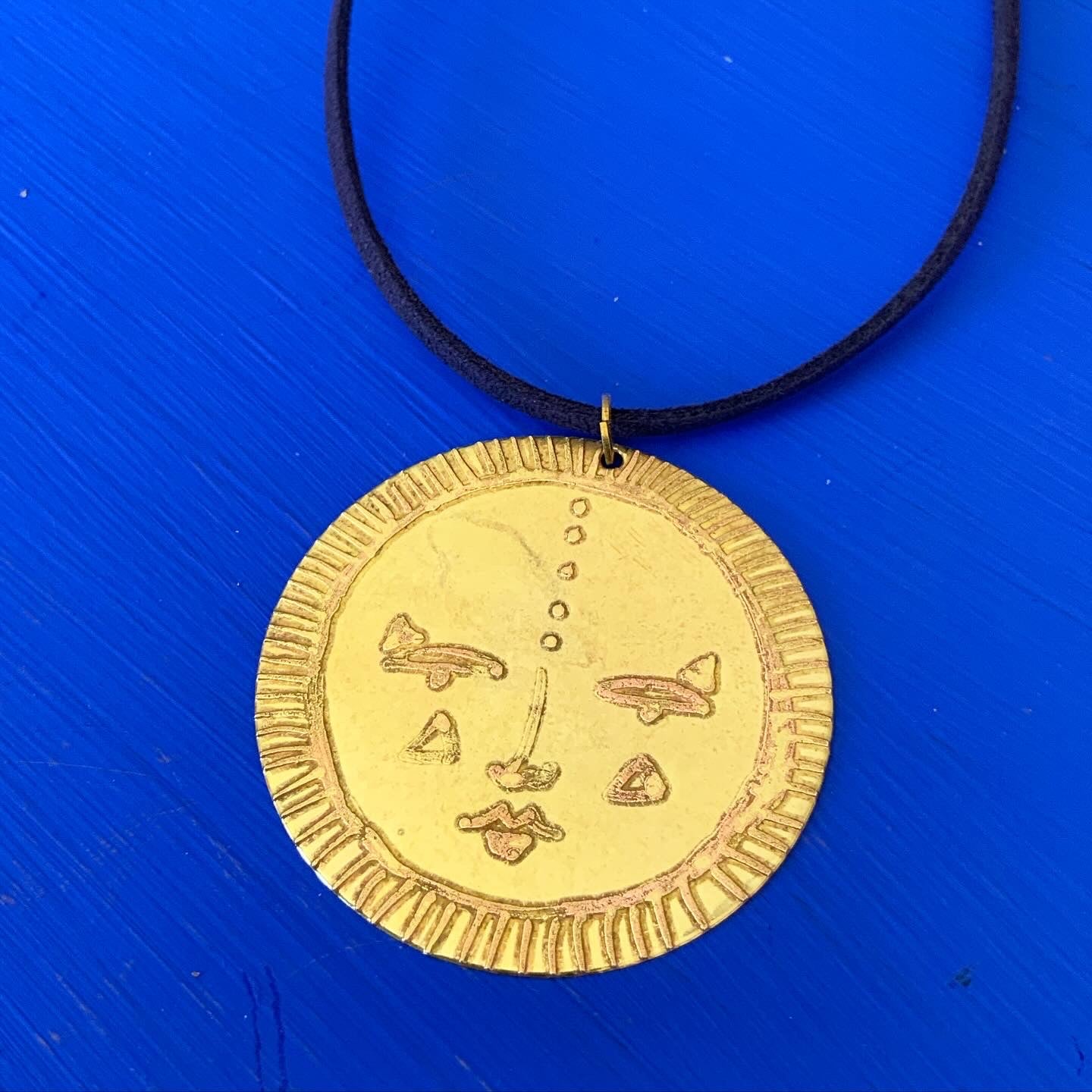 SISTER SUN 22 Brass pendant on blue cord