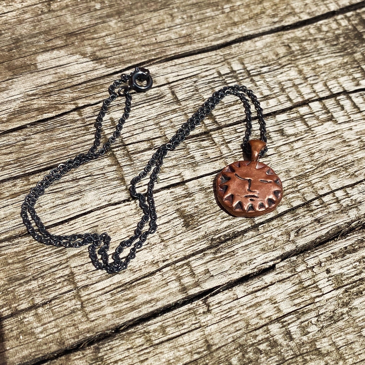 Copper Sun Pendant on Black Chain