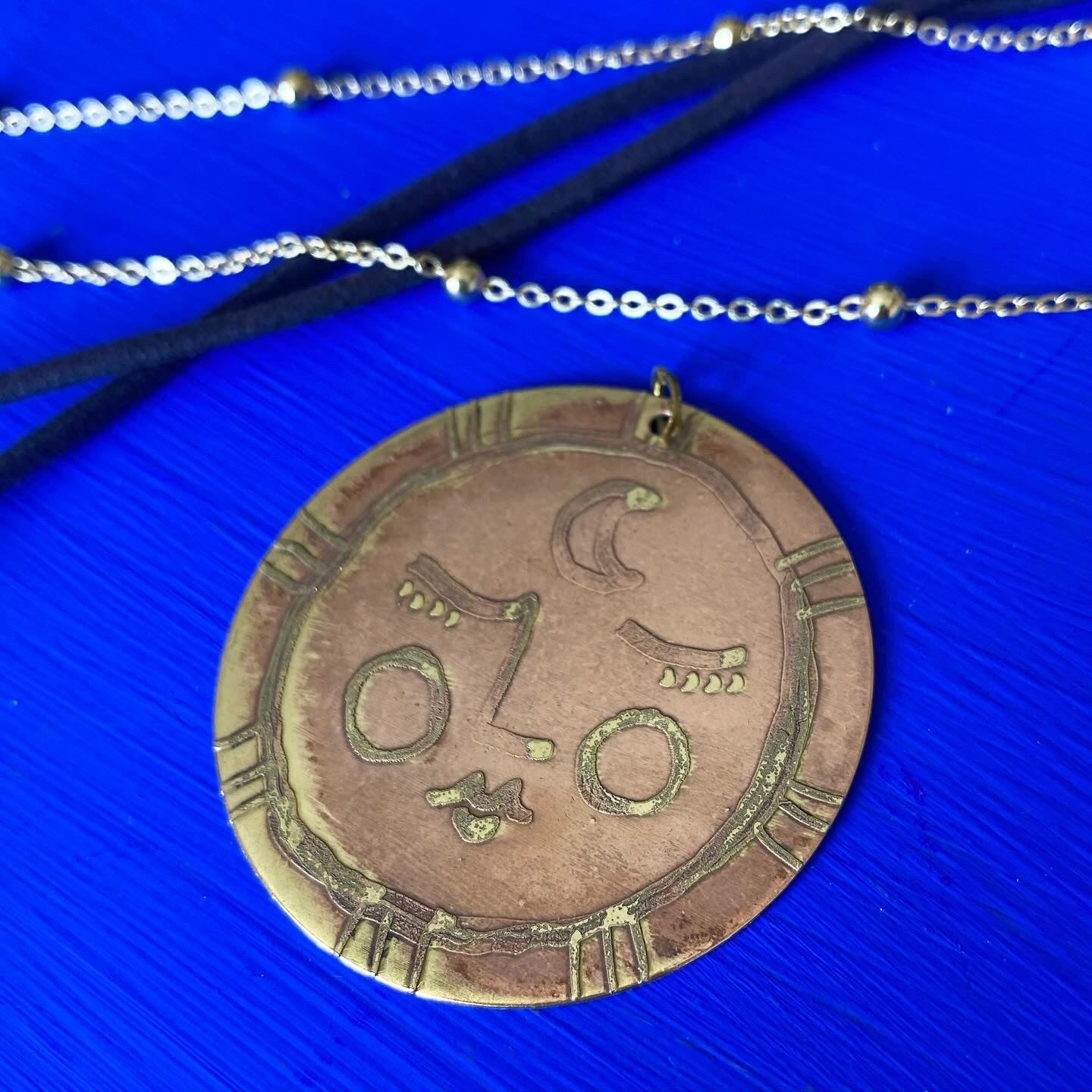 SISTER SUN 8 Brass pendant on blue cord