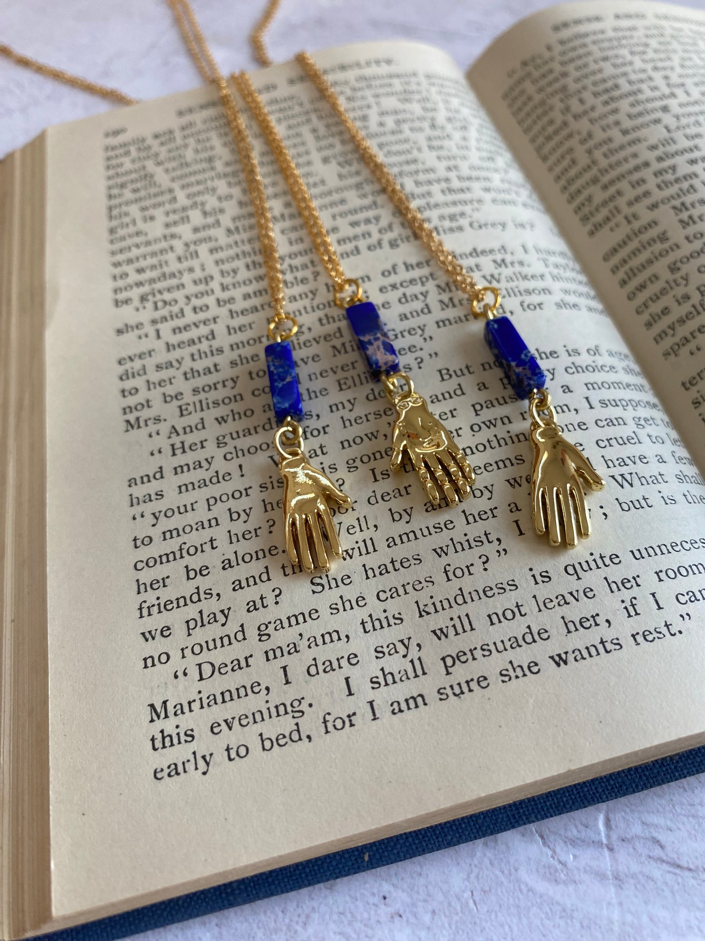 Golden Hand Charm with Lapis Lazuli Bead