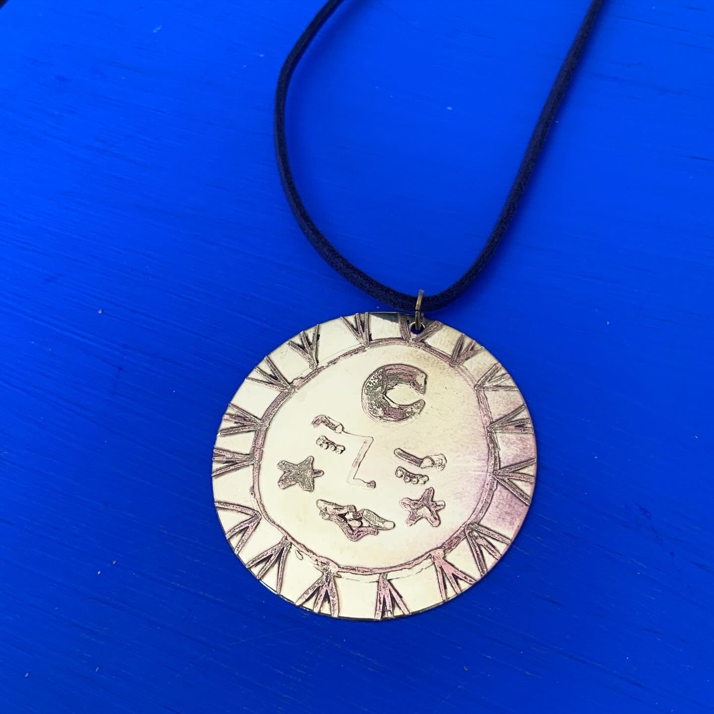 SISTER SUN 24 Brass pendant on blue cord