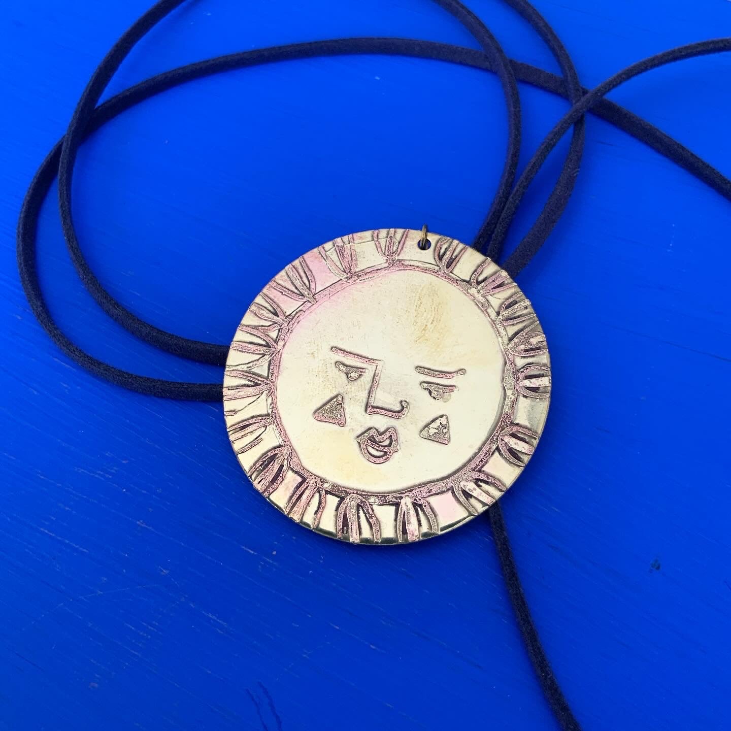 SISTER SUN 32 Brass pendant on blue cord