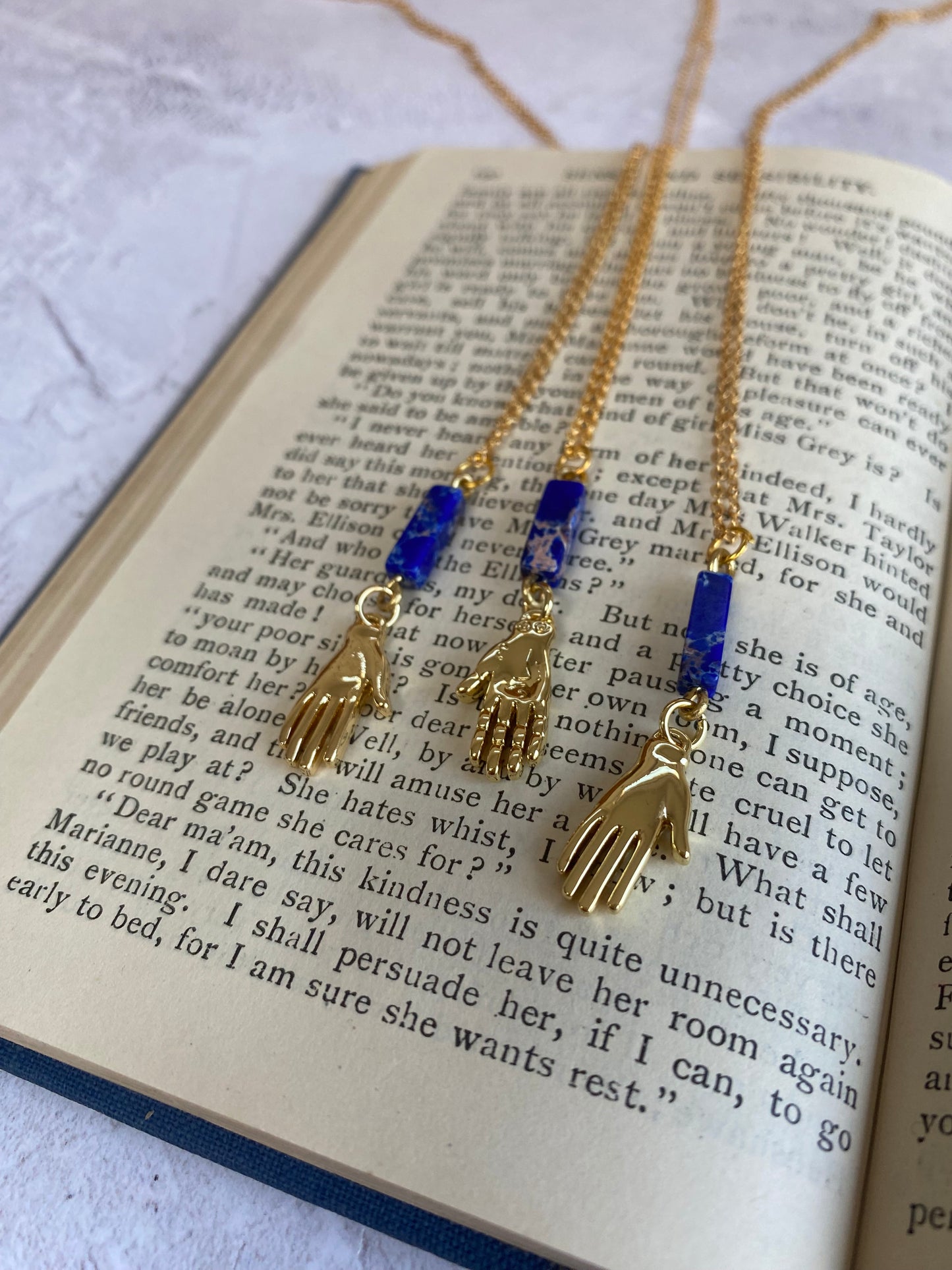 Golden Hand Charm with Lapis Lazuli Bead
