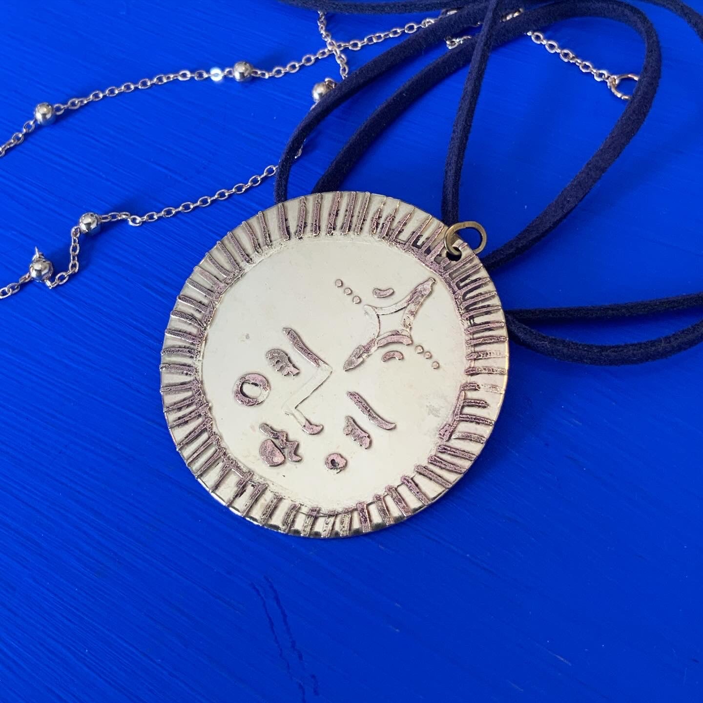 SISTER SUN 15 Brass pendant on blue cord