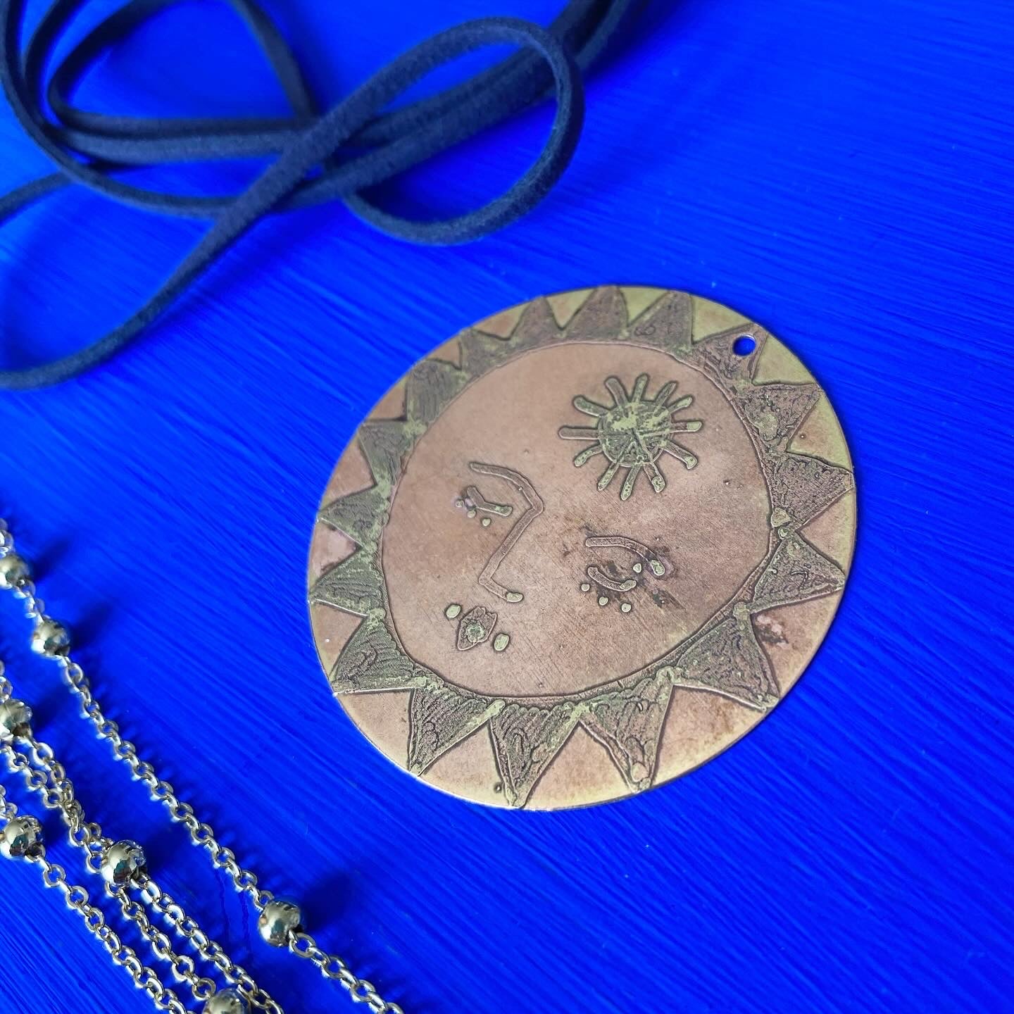 SISTER SUN 7 Brass pendant on blue cord