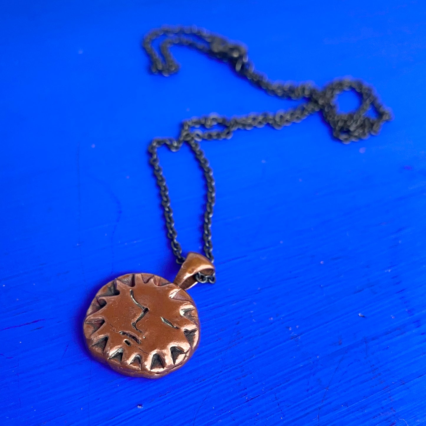 Copper Sun Pendant on Black Chain