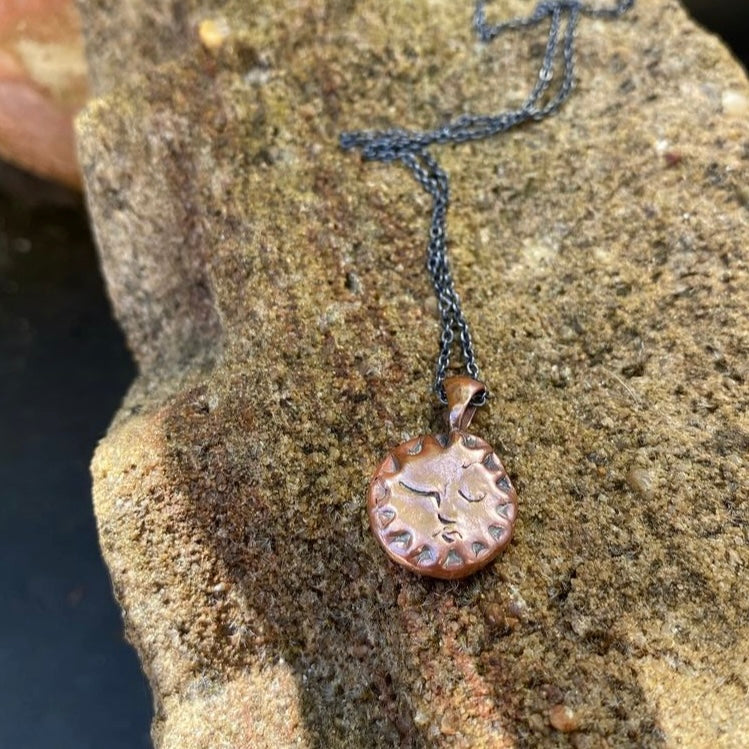 Copper Sun Pendant on Black Chain