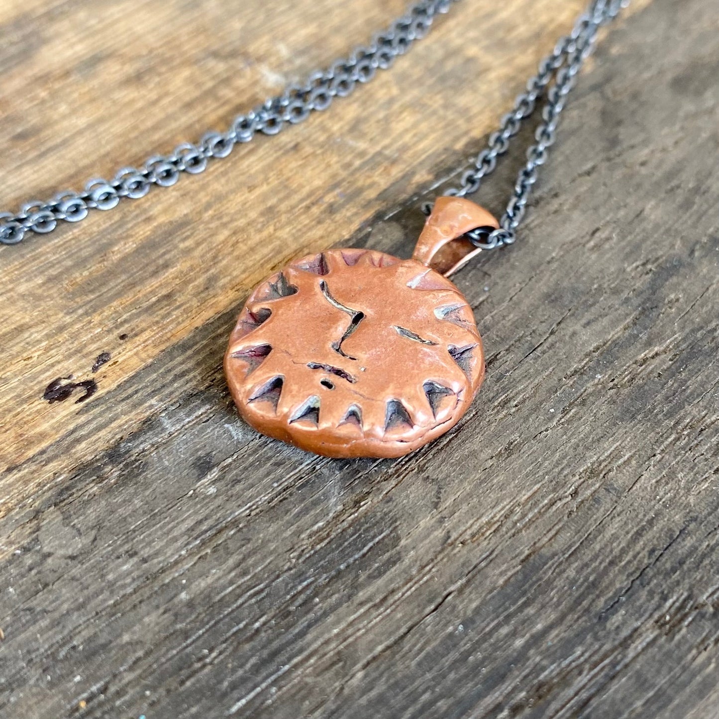 Copper Sun Pendant on Black Chain