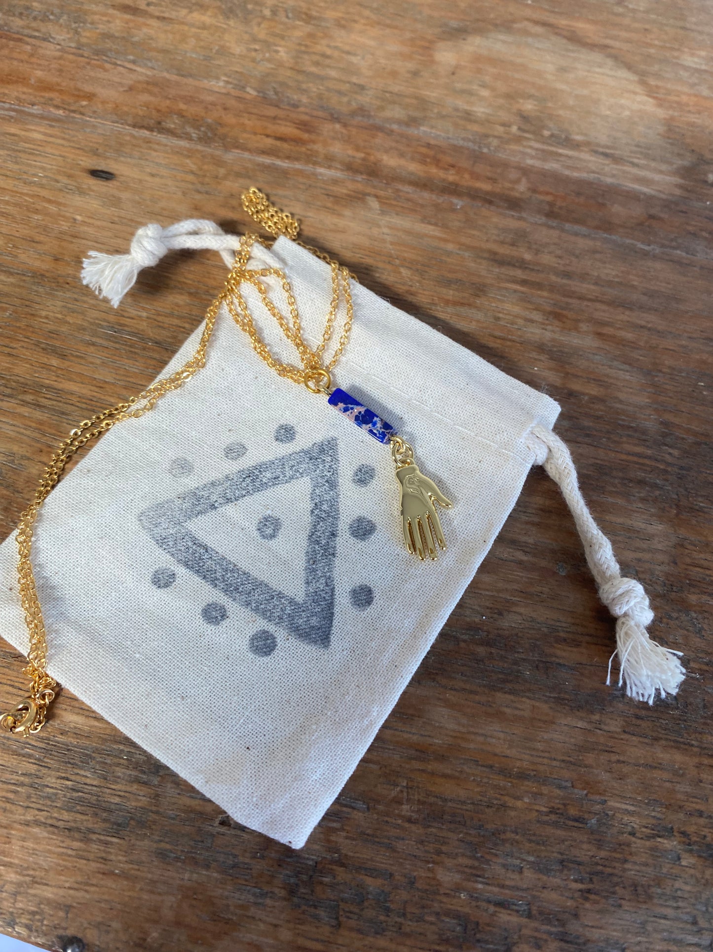 Golden Hand Charm with Lapis Lazuli Bead